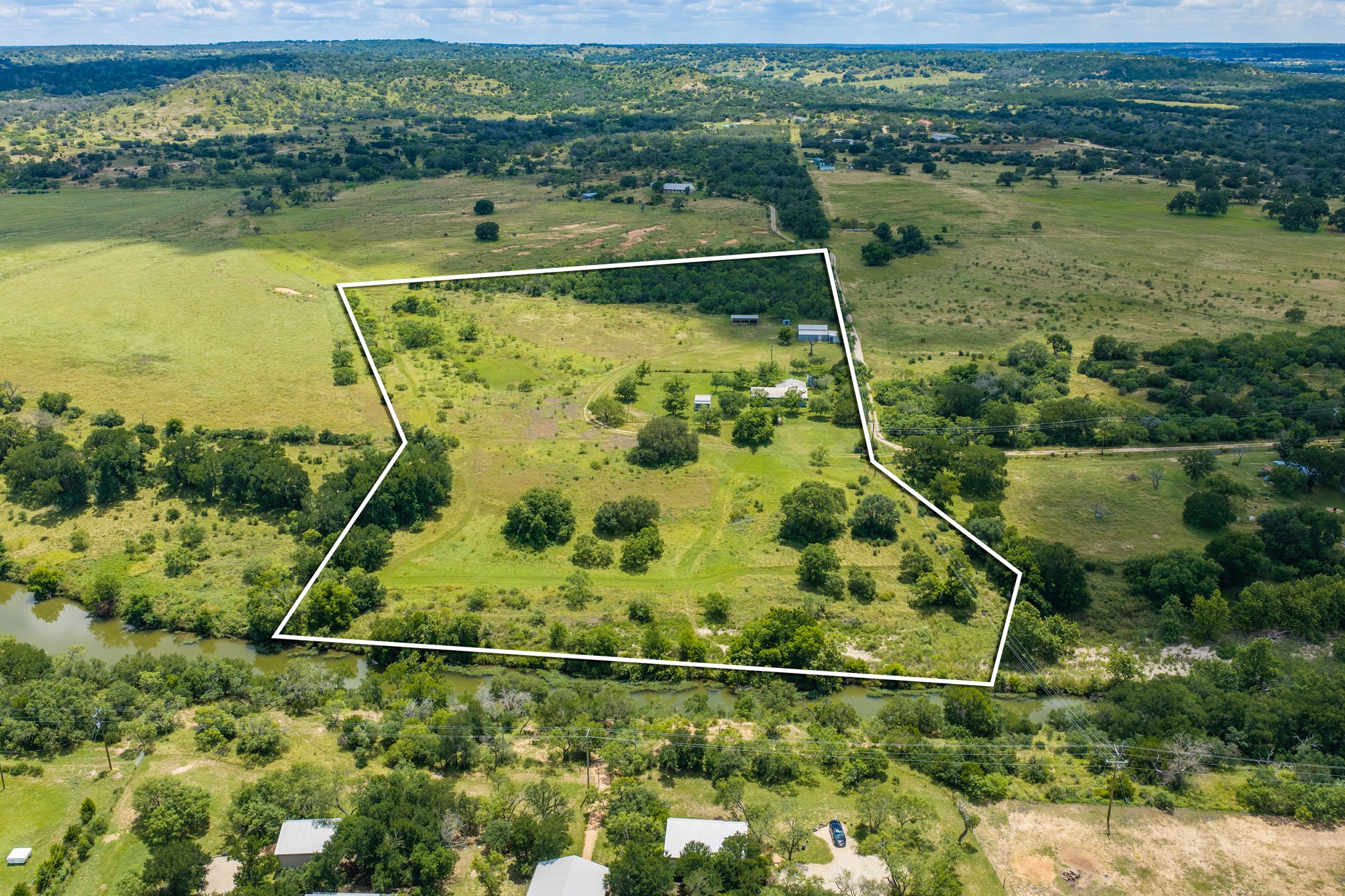 341 River View Road Fredericksburg, TX 78624 - Photo 37 of 40 Rolling green pastures outline this vast countryside acreage bordered by a quiet flowing river.