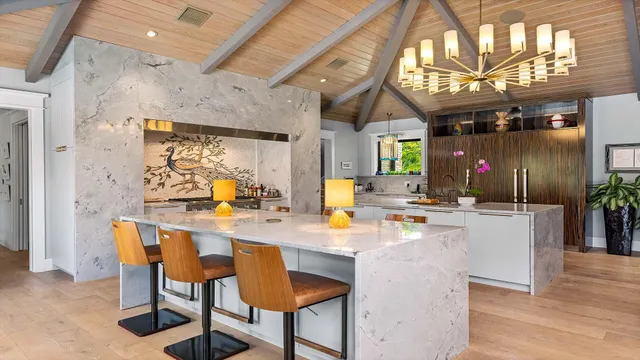 a dining room with furniture a chandelier and wooden floor
