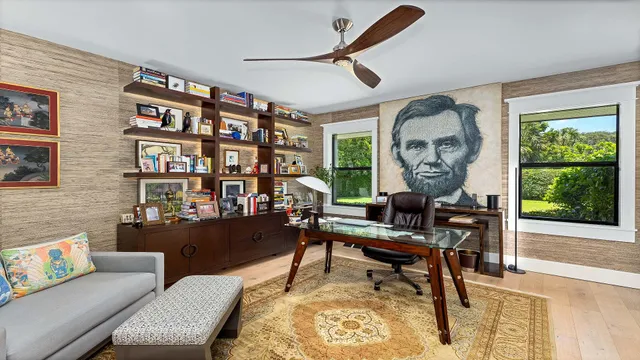 a bedroom with furniture and large windows