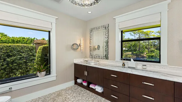 a bathroom with a glass shower door and a window