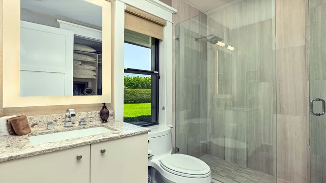 a living room with furniture a flat screen tv and a floor to ceiling window