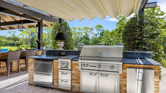 a view of a house with pool and chairs