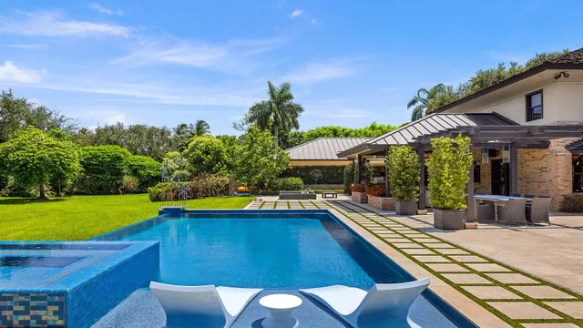 a view of a swimming pool with an outdoor space and seating area