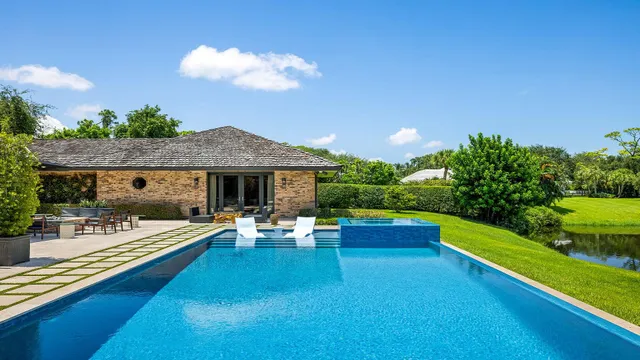 a front view of house with yard barbeque oven and outdoor seating