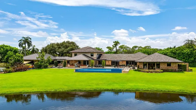 an aerial view of a houses with a yard