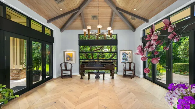 a living room with furniture and flower vase