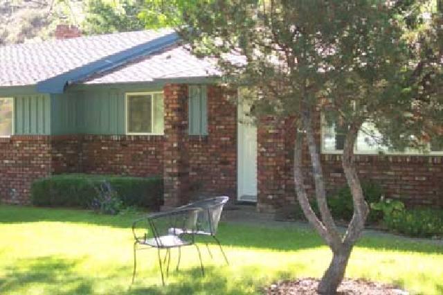 a view of house with backyard outdoor seating and plants