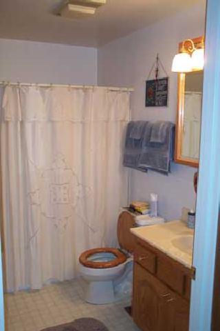 1191 Stone Road Yakima, WA 98908 - Photo 4 of 7 a bathroom with a granite countertop toilet and a mirror