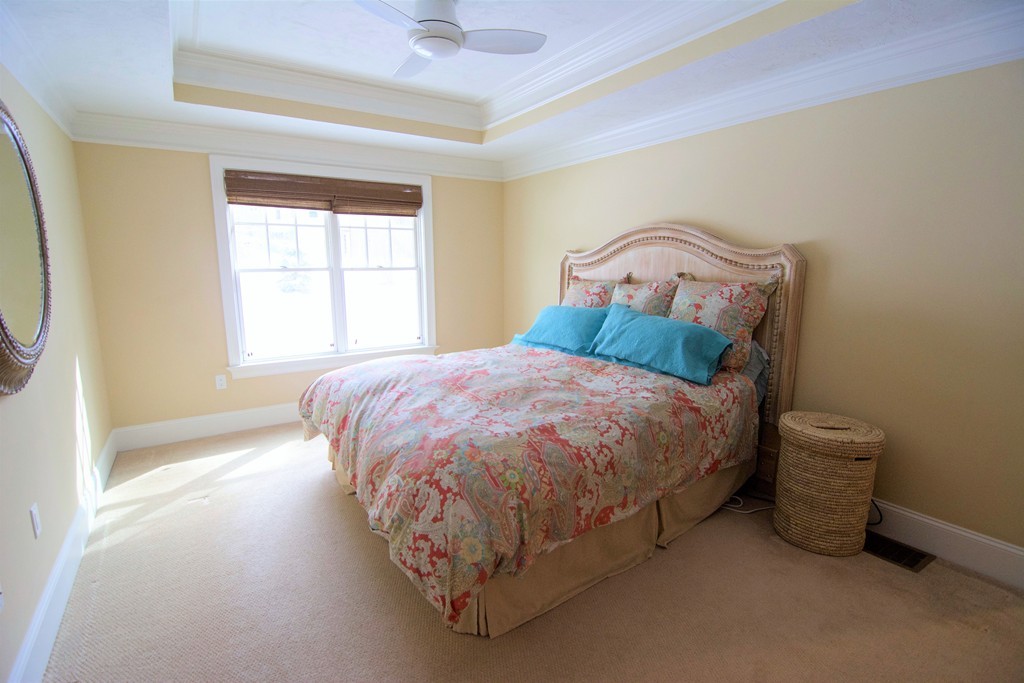 30 Nobscot Road, Unit 24 Sudbury, MA 01776 - Photo 14 of 24 a bed sitting in a bedroom next to a window