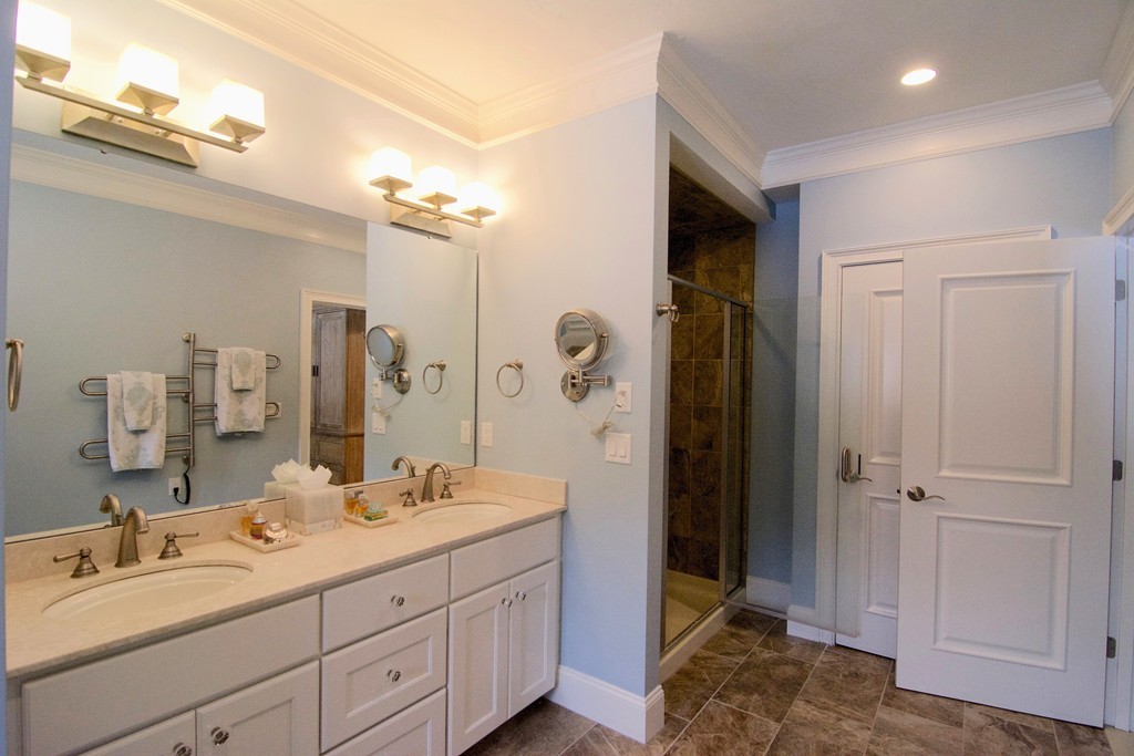 30 Nobscot Road, Unit 24 Sudbury, MA 01776 - Photo 15 of 24 a bathroom with a double vanity sink shower and a mirror
