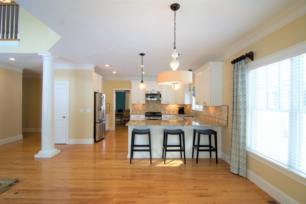 30 Nobscot Road, Unit 24 Sudbury, MA 01776 - Photo 23 of 24 a room with stainless steel appliances kitchen island granite countertop a table chairs and a refrigerator