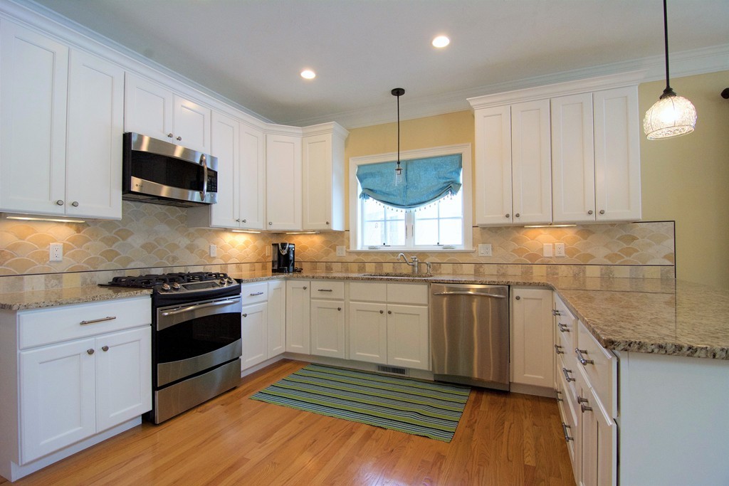 30 Nobscot Road, Unit 24 Sudbury, MA 01776 - Photo 4 of 24 a kitchen with granite countertop a sink stainless steel appliances and cabinets