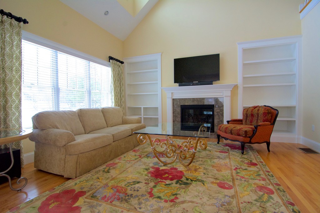 30 Nobscot Road, Unit 24 Sudbury, MA 01776 - Photo 10 of 24 a living room with furniture a flat screen tv and a fireplace
