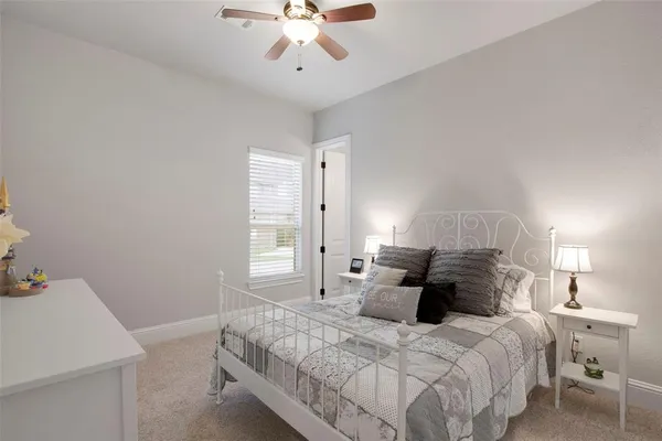a bed room with a bed and a chandelier
