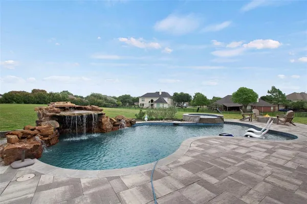a view of a lake with a yard and outdoor seating