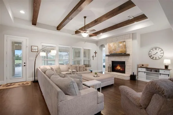 a living room with furniture fireplace and a large window