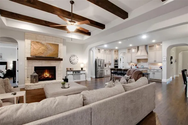 a living room with furniture kitchen view and a fireplace