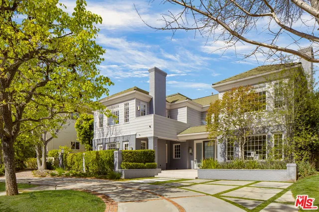 a front view of a building with a garden