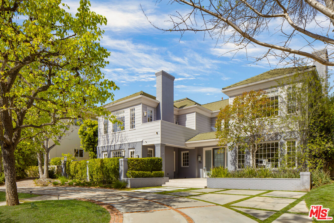 a front view of a building with a garden