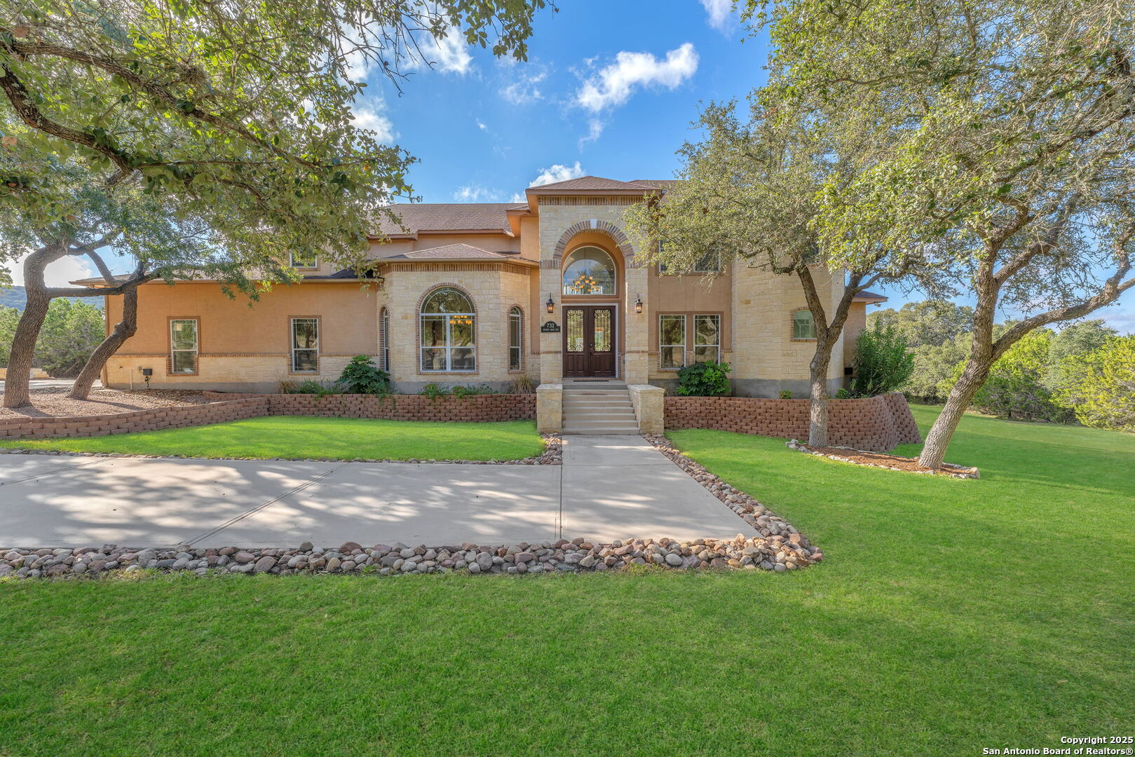 a front view of a house with a garden and yard