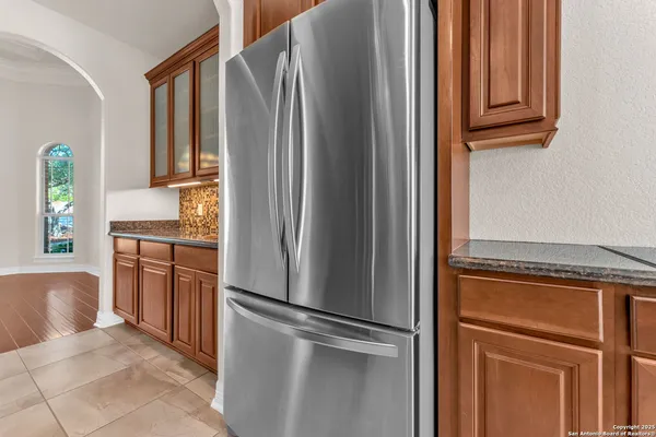a kitchen with a refrigerator and cabinets
