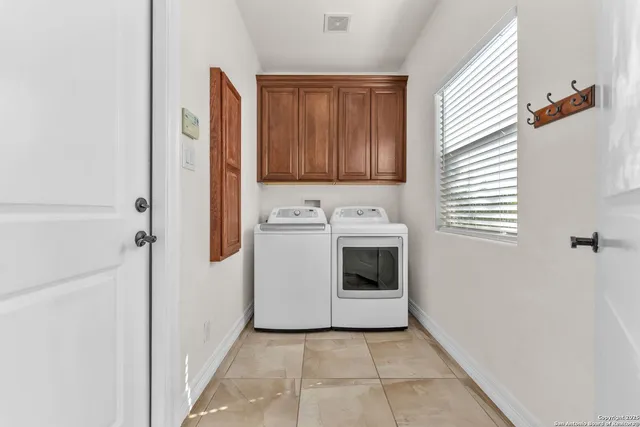 a view of a dining room with furniture a chandelier and wooden floor