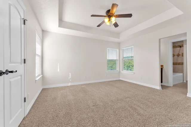 a view of an empty room with a fan