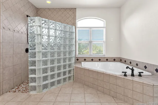 a bathroom with a bathtub and a shower