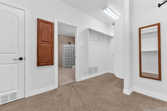 a kitchen with granite countertop a stove a sink and a refrigerator