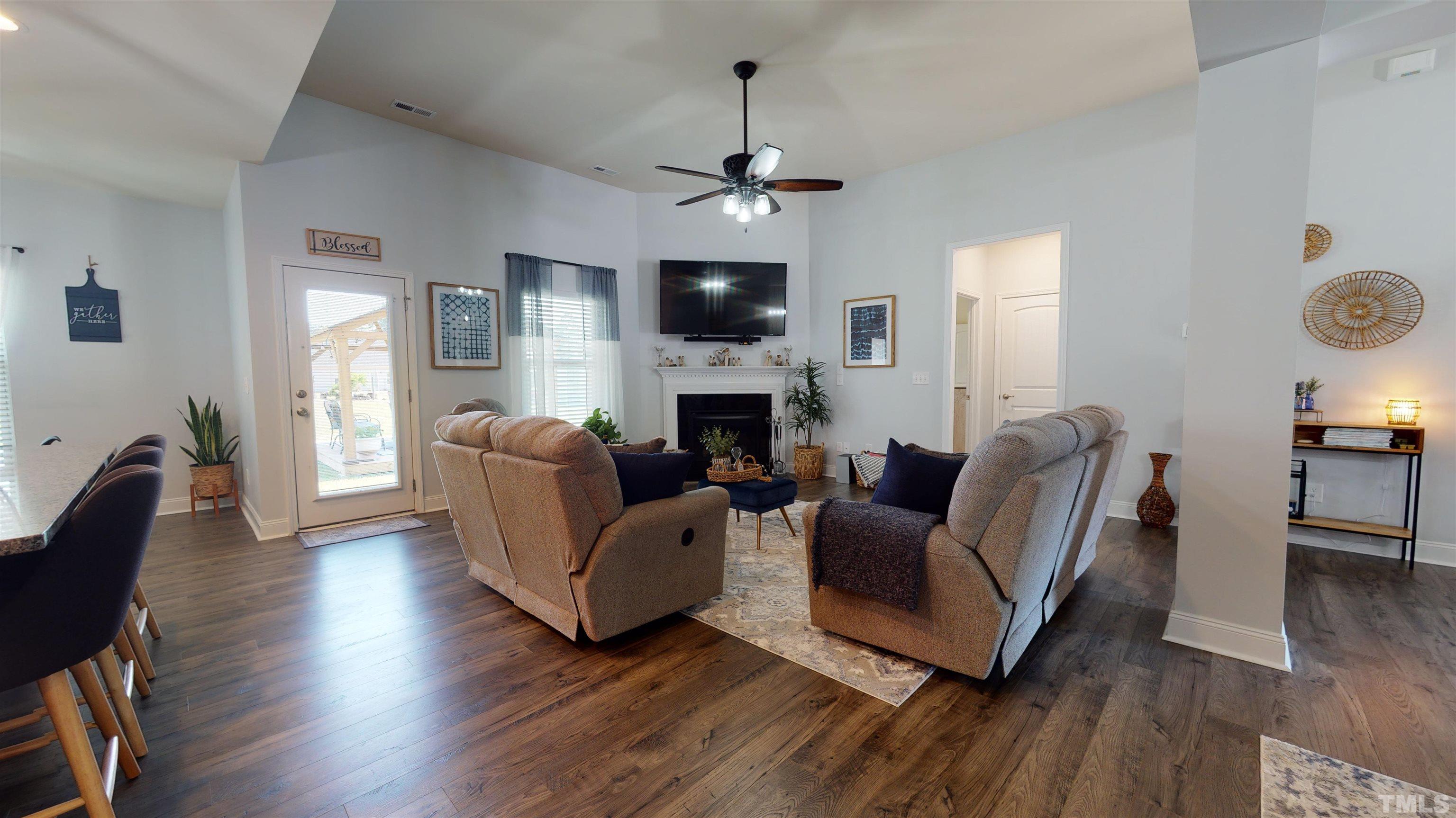96 Longo Lane Benson, NC 27504 - Photo 13 of 51 a living room with furniture a fireplace and a flat screen tv