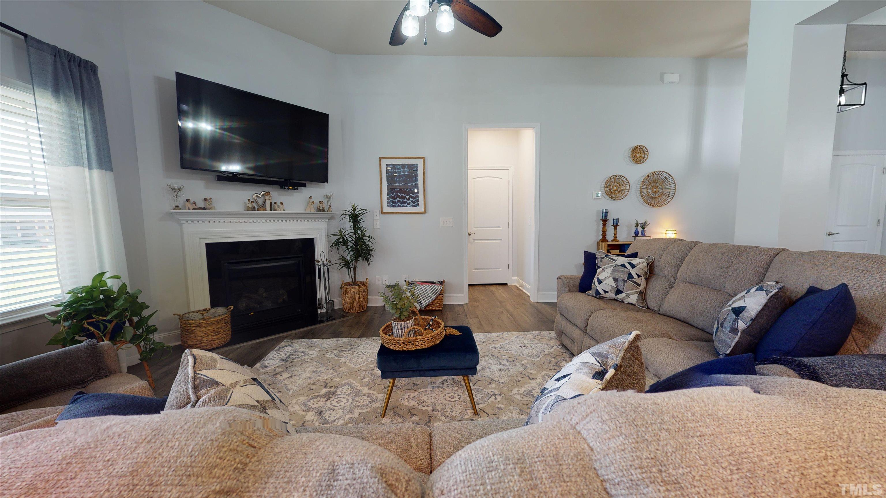 96 Longo Lane Benson, NC 27504 - Photo 18 of 51 a living room with furniture a fireplace and a flat screen tv