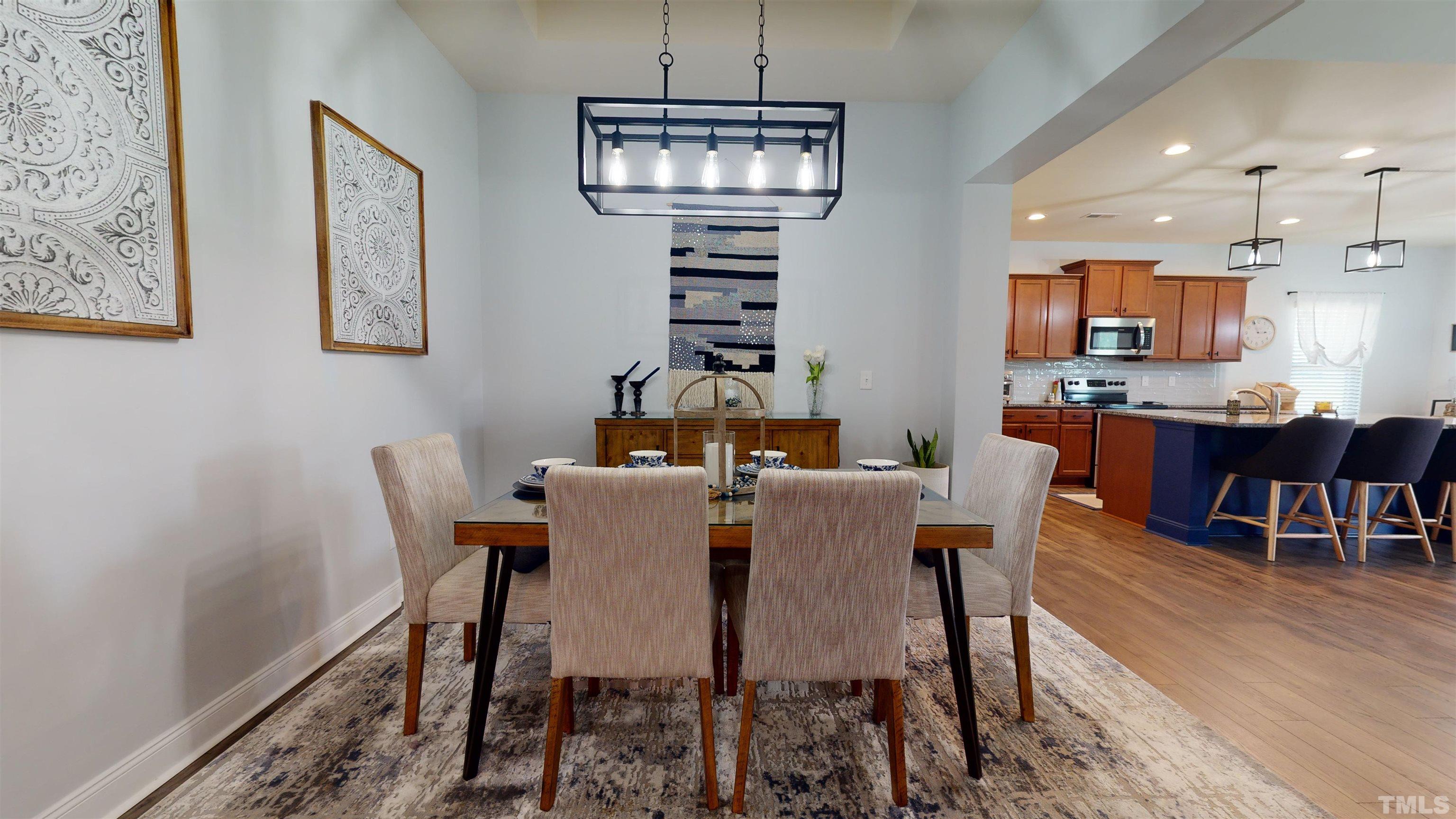 96 Longo Lane Benson, NC 27504 - Photo 22 of 51 a view of a dining room with furniture wooden floor and chandelier