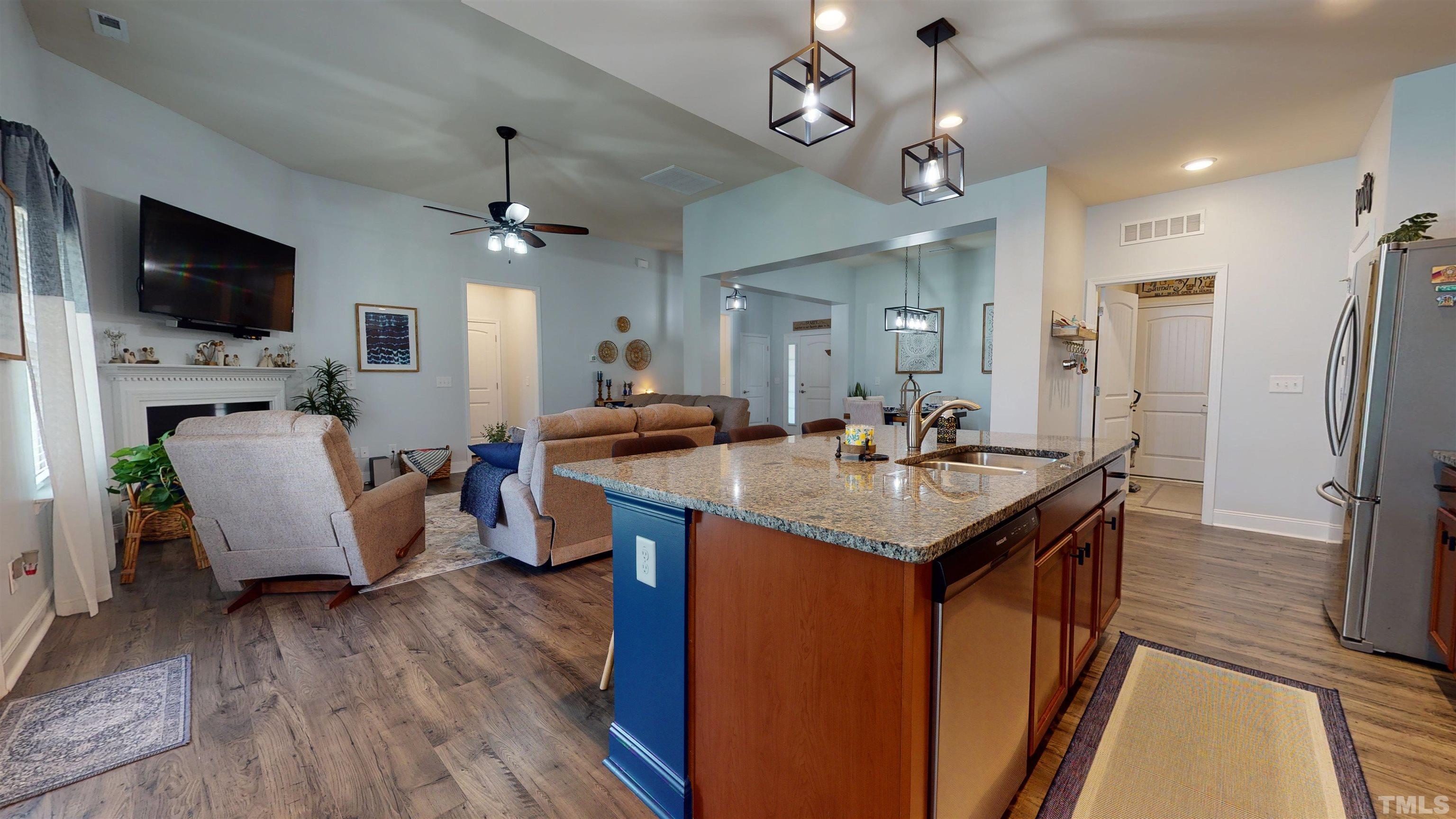 96 Longo Lane Benson, NC 27504 - Photo 26 of 51 a kitchen with a refrigerator a sink dishwasher a dining table and chairs with wooden floor