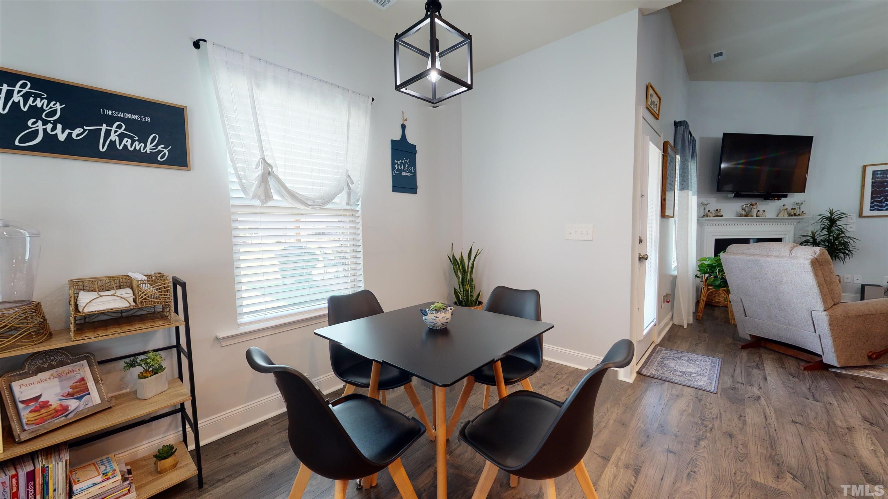 96 Longo Lane Benson, NC 27504 - Photo 28 of 51 a view of a dining room with furniture window and wooden floor