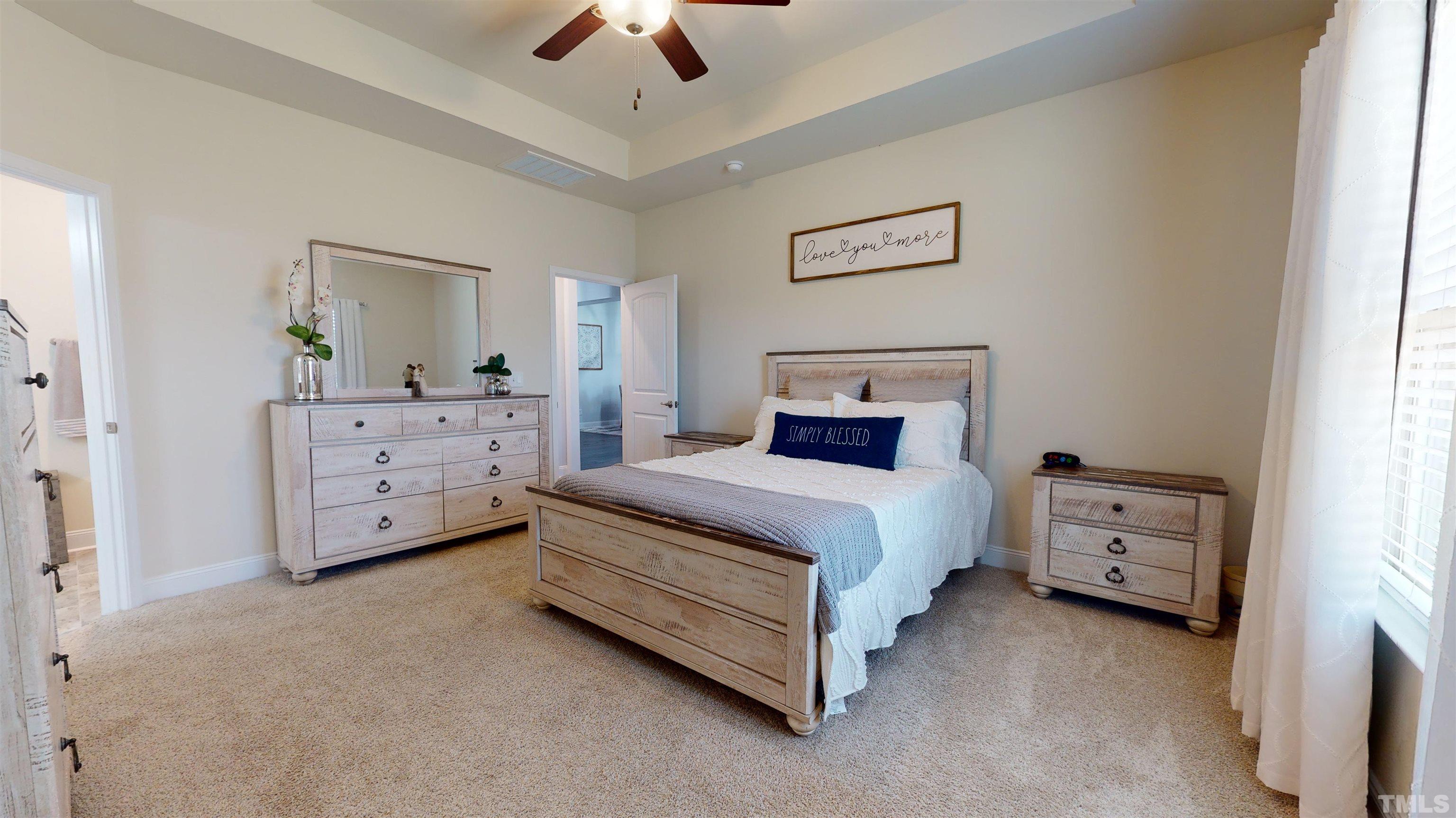 96 Longo Lane Benson, NC 27504 - Photo 29 of 51 a bedroom with a bed and a chandelier