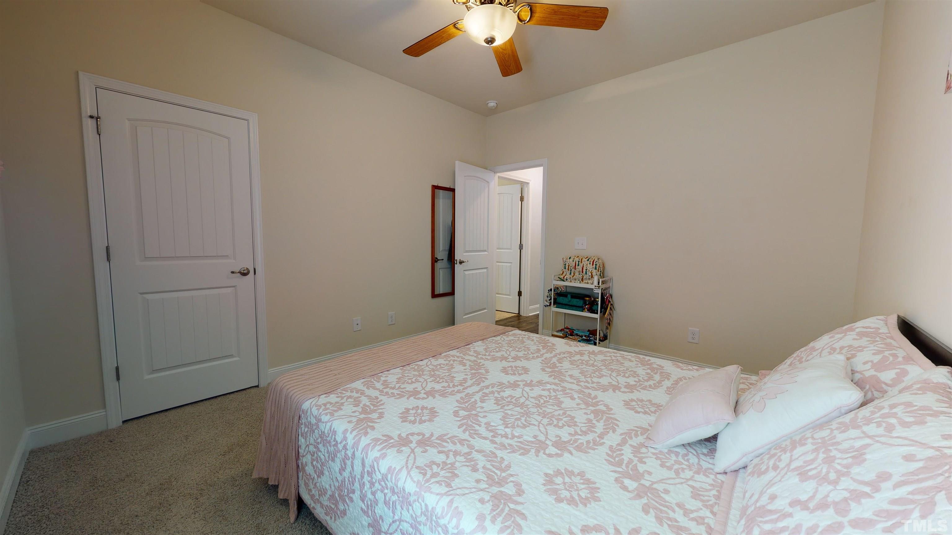96 Longo Lane Benson, NC 27504 - Photo 32 of 51 a bedroom with a bed and a chandelier