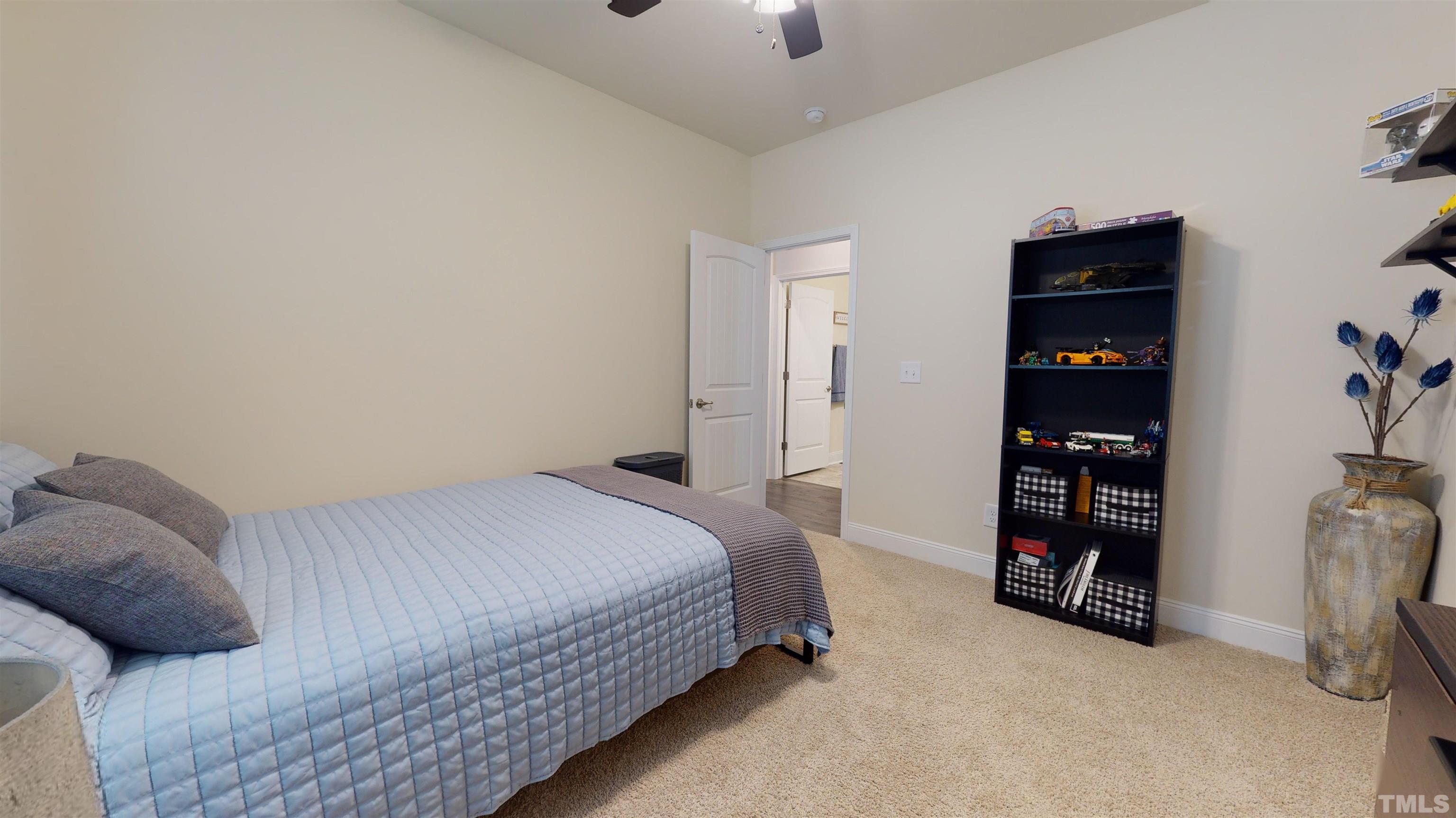96 Longo Lane Benson, NC 27504 - Photo 34 of 51 a bedroom with a bed and a walk in closet