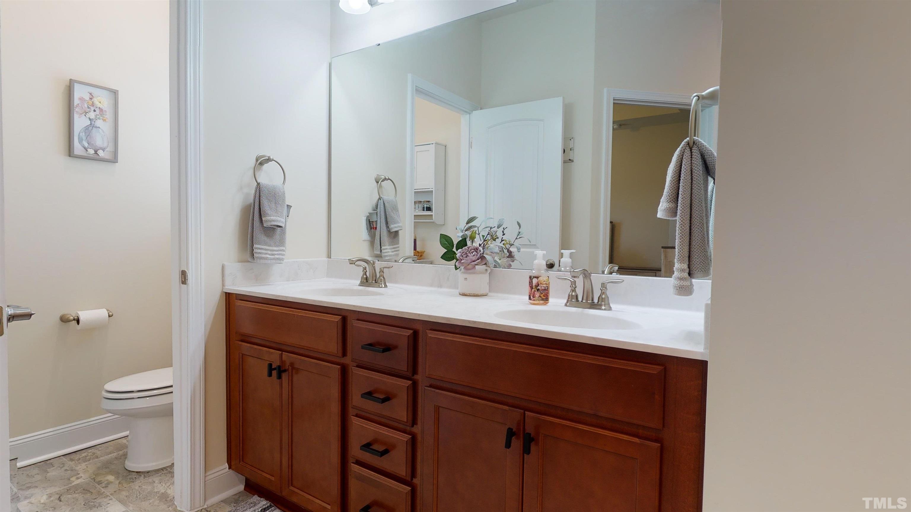 96 Longo Lane Benson, NC 27504 - Photo 35 of 51 a bathroom with a granite countertop sink a toilet and a mirror