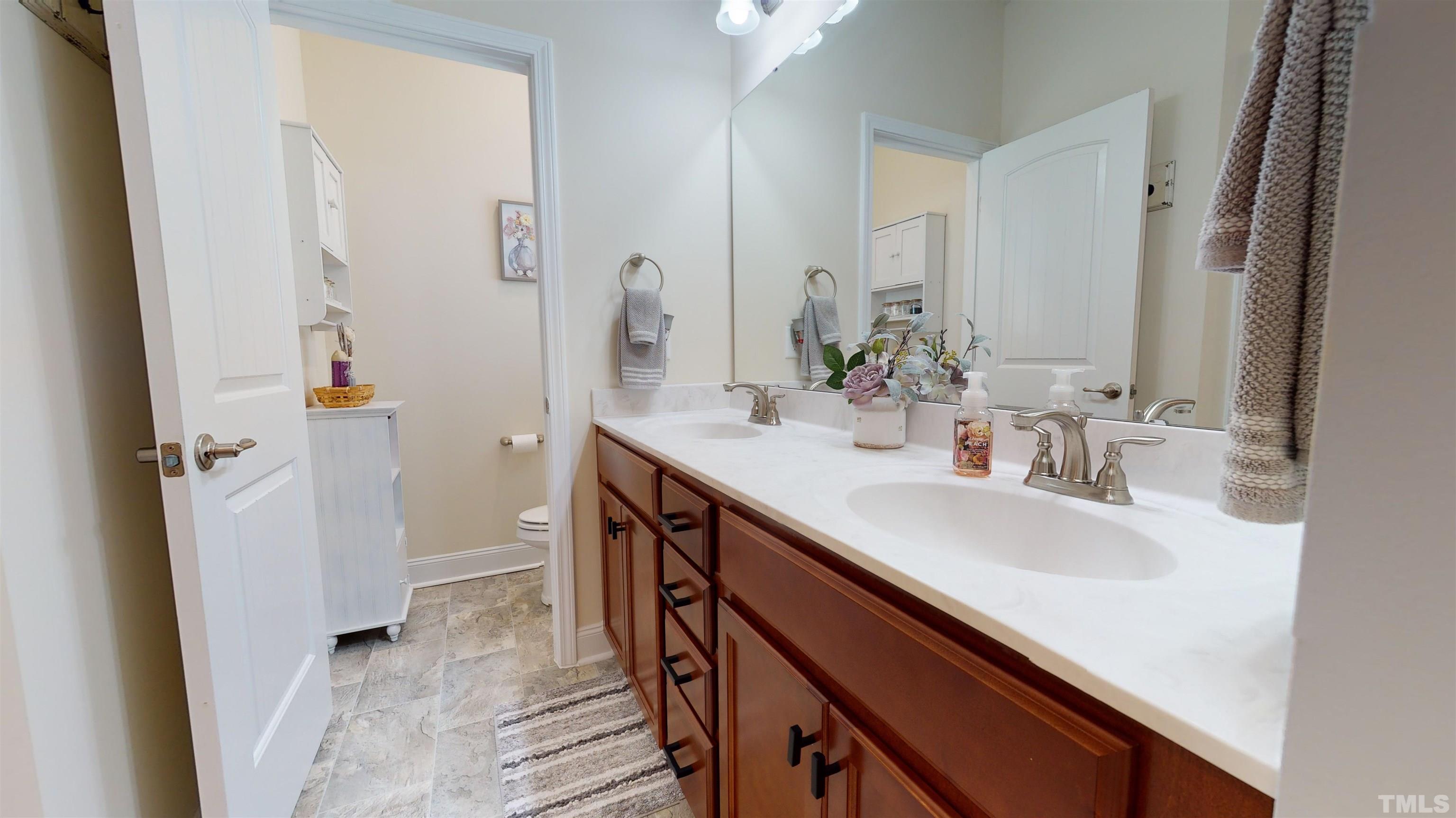 96 Longo Lane Benson, NC 27504 - Photo 37 of 51 a bathroom with a sink a mirror and a shower