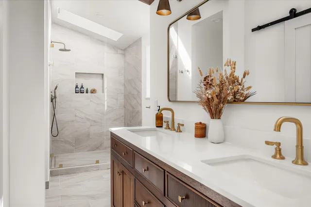 a bathroom with a sink a vanity and a mirror