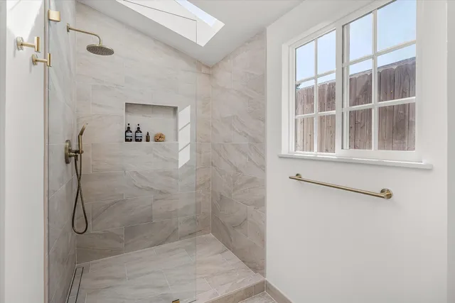 a bathroom with a glass shower door