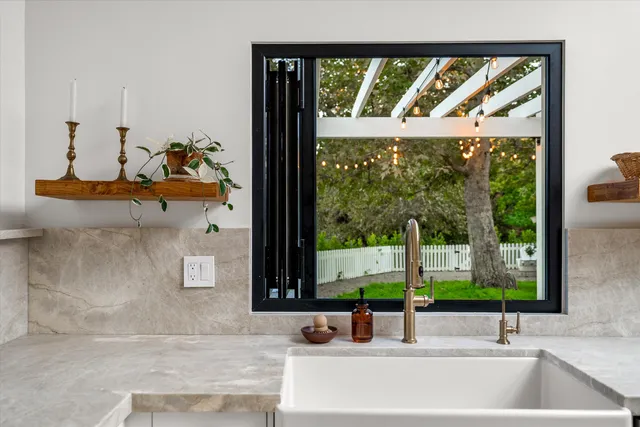 a view of a yard with large trees and plants in front of it