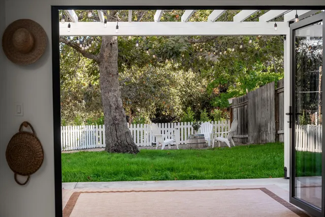 a view of a patio with a table chairs and a backyard
