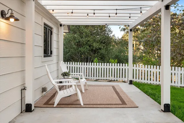 a front view of a house with a garden and sitting area