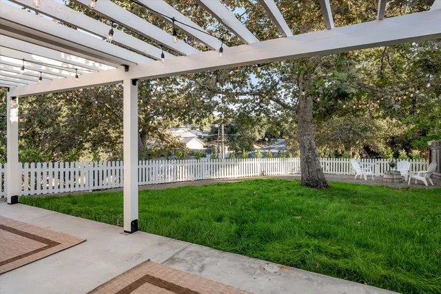 a front view of a house with a garden and yard