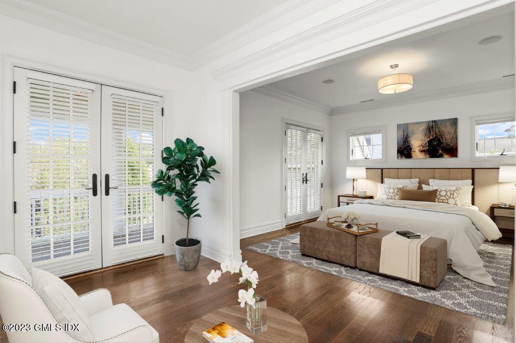 24 Orchard Place, Unit A Greenwich, CT 06830 - Photo 11 of 15 a bedroom with a large bed and a flat tv screen