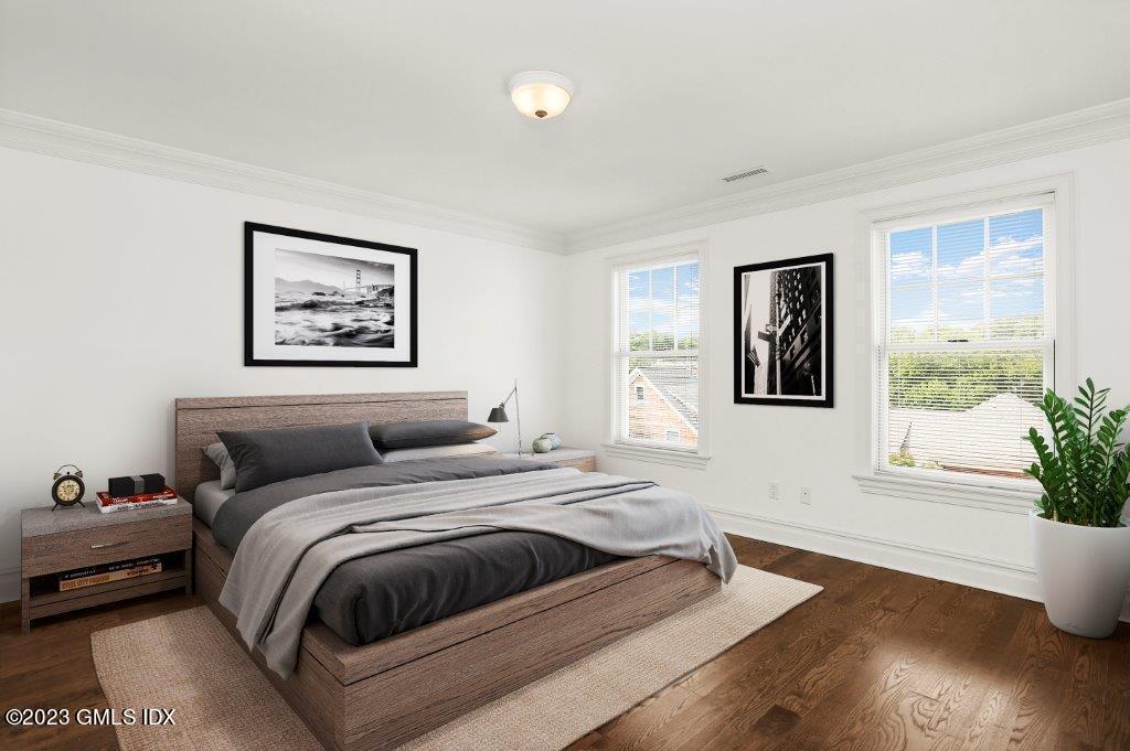 24 Orchard Place, Unit A Greenwich, CT 06830 - Photo 12 of 15 a bedroom with a large bed and a painting on the wall