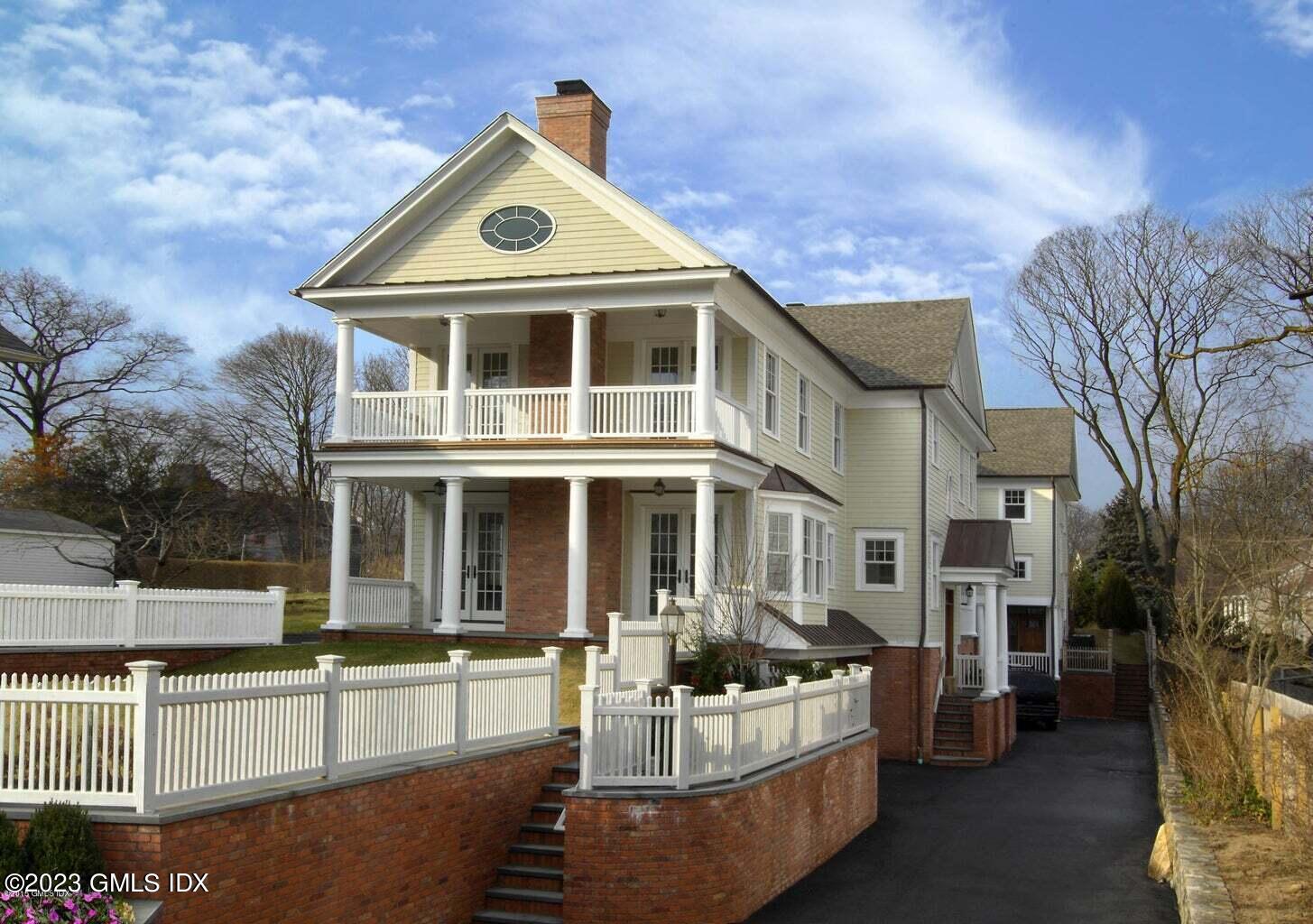 24 Orchard Place, Unit A Greenwich, CT 06830 - Photo 2 of 15 a front view of a house with a yard