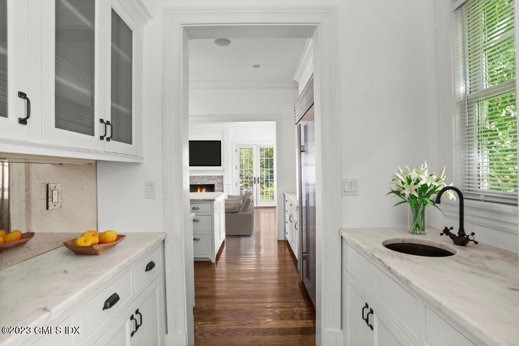 24 Orchard Place, Unit A Greenwich, CT 06830 - Photo 9 of 15 a kitchen with a sink a counter space and wooden floor