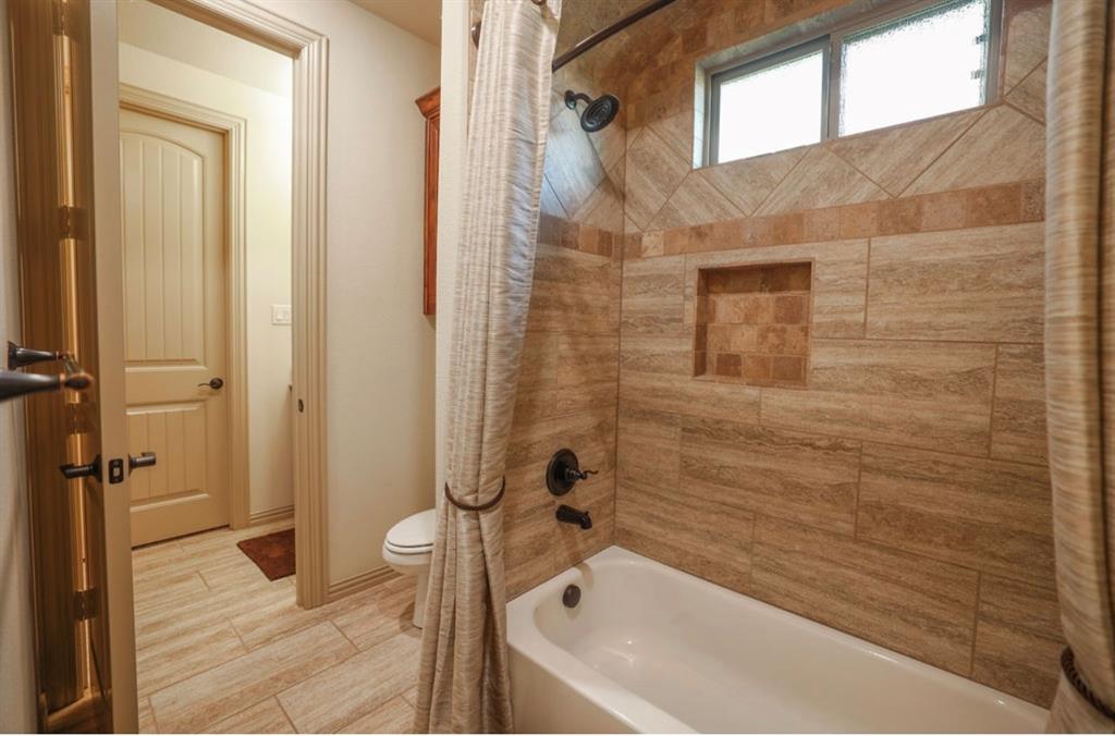 1387 Shadow Lakes Drive Wills Point, TX 75169 - Photo 22 of 33 a bathroom with a bathtub and shower